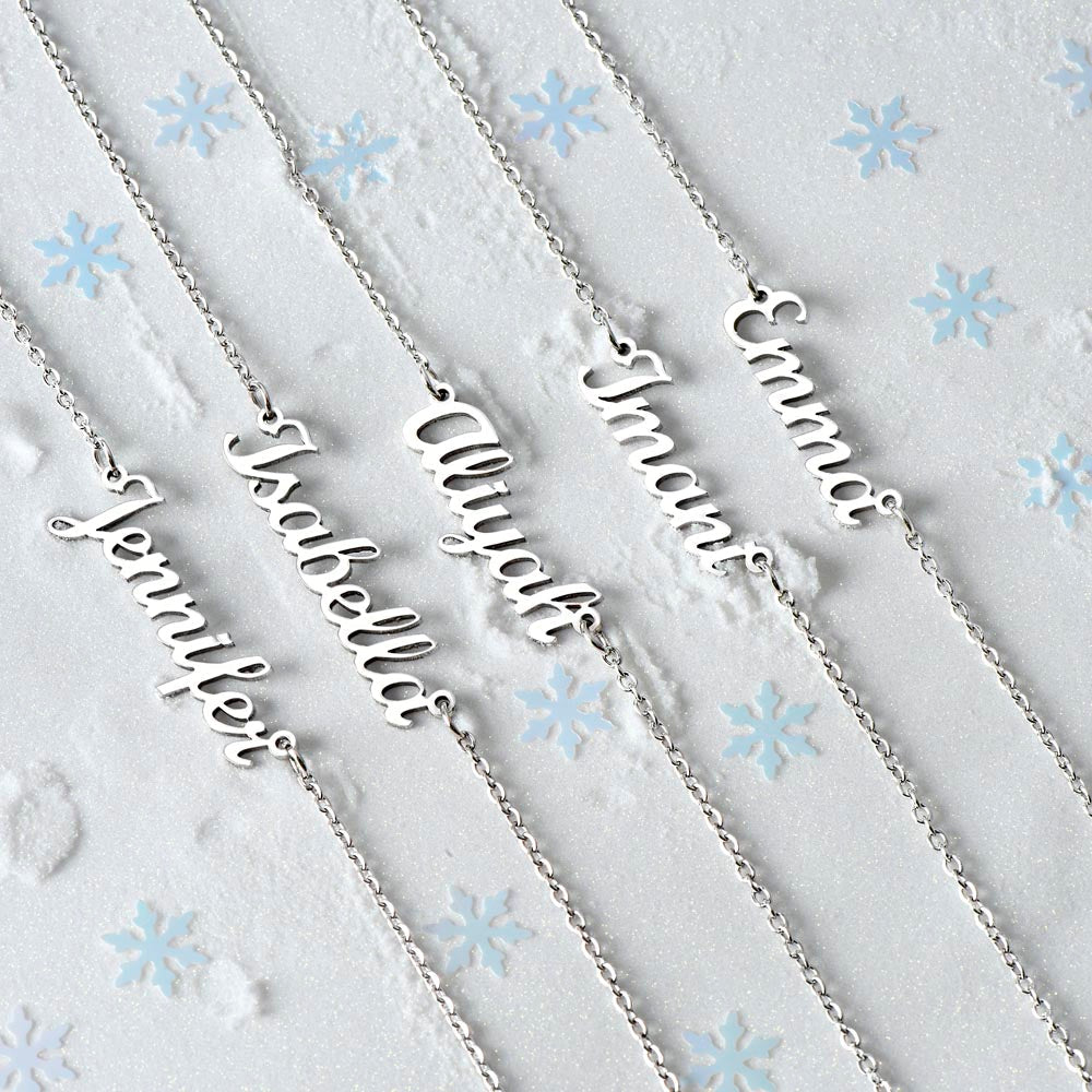 Personalised name necklace in silver on a snowy background